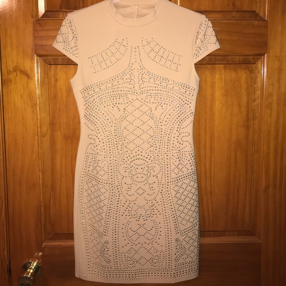 A nude studded body con dance dress